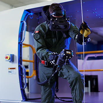 Bucket Image. Man wearing VR headset holding a device and cable