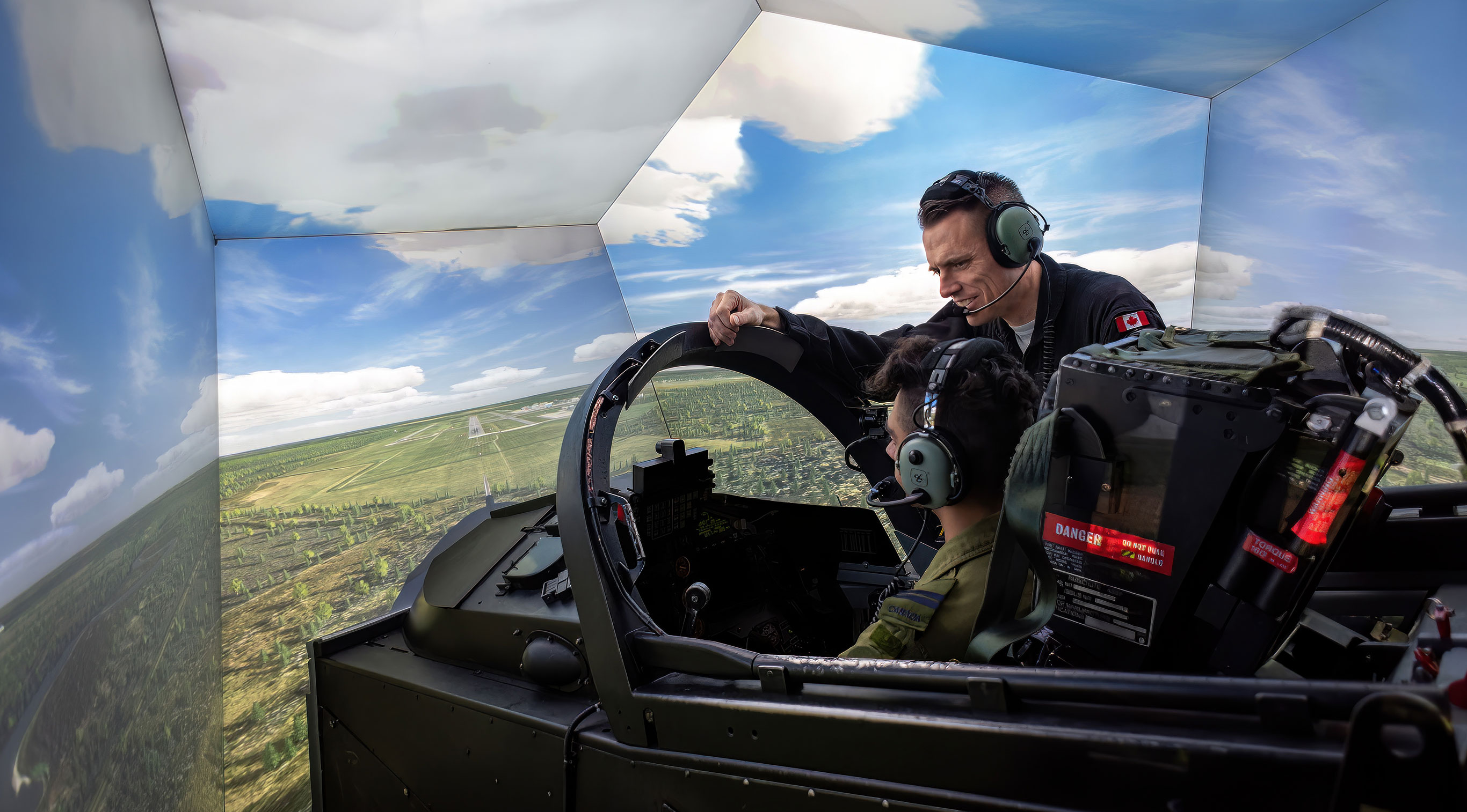 Header Image. Two men in the cockpit of a fighter simulator